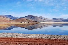 39 Hills Reflect Perfectly In The Water Just After Leaving Paryang Tibet For Mount Kailash The colourful hills of Tibet reflect perfectly in the water after leaving Paryang Tibet for Mount Kailash.